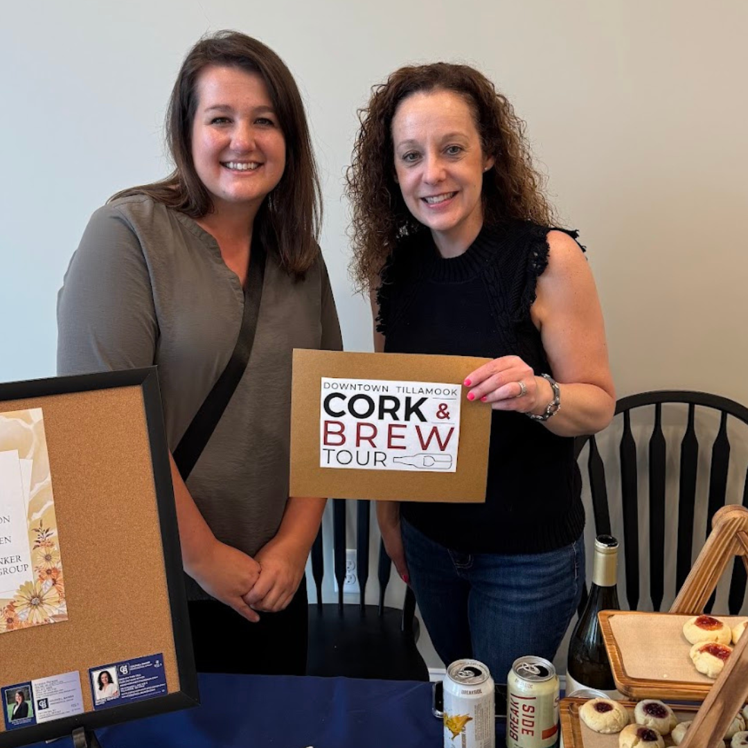 two women holding a cork and brew sign